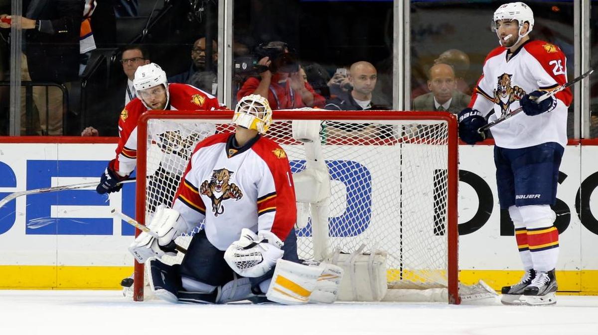 Florida Panthers defenseman Aaron Ekblad (5), goalie Roberto Luongo (1) and right wing Teddy Purcell (26) react after losing 2-1 to the New York Islanders in the second overtime period of Game 6 of an NHL hockey first-round Stanley Cup playoff series in New York, Sun., April 24, 2016. The Islanders eliminated the Florida Panthers winning the series four games to two.