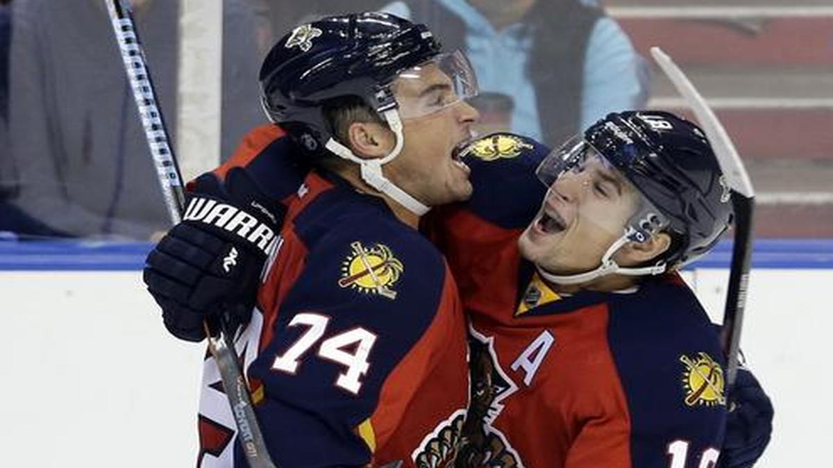 
Florida Panthers defenseman Shane O'Brien (74) and Florida Panthers right wing Scottie Upshall (19) celebrate O'Brien's goal against the Dallas Stars in the second period of an NHL hockey preseason game, in Sunrise, Fla., Wednesday, Sept. 24, 2014. 
