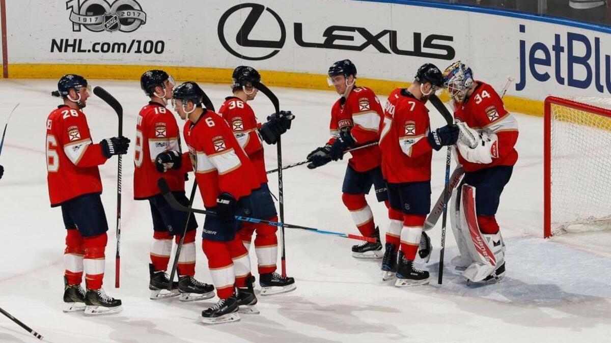 Florida Panthers goaltender James Reimer (34) is congratulated by teammates at the end of the third period of an NHL hockey game against the Chicago Blackhawks, Saturday, March 25, 2017, in Sunrise, Fla. The Panthers defeated the Blackhawks 7-0.
