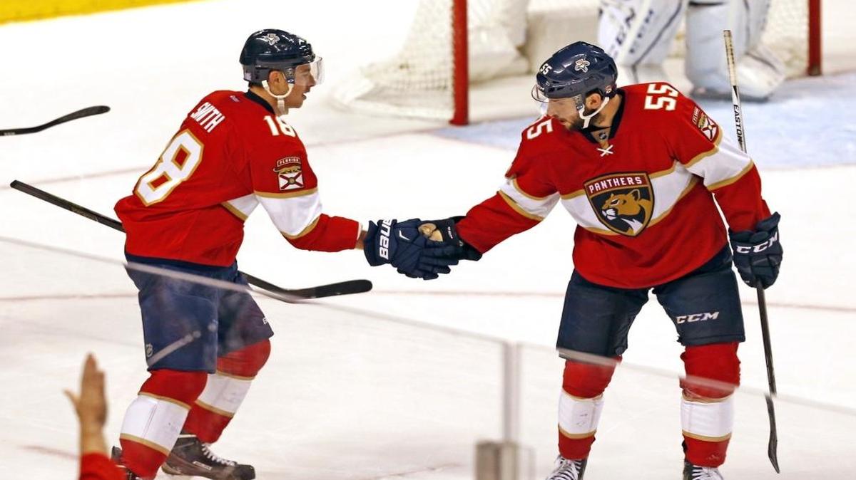 Florida Panthers Reilly Smith gets congratulations from teammate Jason Demer after Smith scored the winning goal as they play the Tampa Bay Lighting at the BB&T Center in Sunrise, Florida, November 7, 2016.