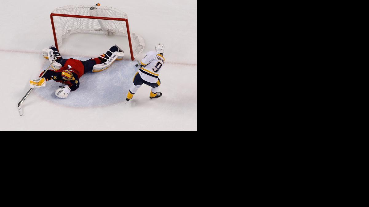 
Filip Forsberg #9 of the Nashville Predators scores the winning goal during the shootout against goaltender Roberto Luongo #1 of the Florida Panthers at the BB&T Center on February 8, 2015 in Sunrise, Florida. The Predators defeated the Panthers 3-2 in a shootout. 
