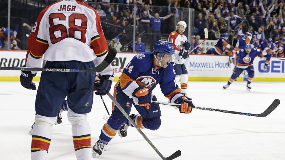 New York Islanders defenseman Thomas Hickey (14) celebrates scoring the game-winning goal in front of Florida Panthers right wing Jaromir Jagr (68) during overtime in Game 3 of an NHL hockey first-round Stanley Cup playoff series Sun., April 17, 2016, in New York. The Islanders won 4-3.