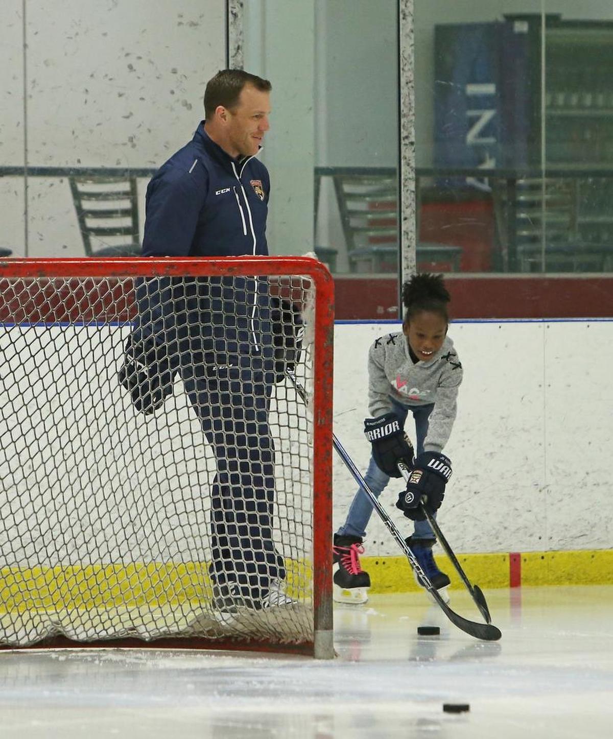 Former Florida Panthers player and now vice president of business operations Shawn Thornton gives a private hockey clinic to eleven-year-old Jessica King of Barbados at the Florida Panthers IceDen in Coral Springs on Wednesday, December 6, 2017. Thornton met Jessica in August when they hosted the first ice hockey clinic in the Caribbean on a synthetic ice rink in Barbados.
