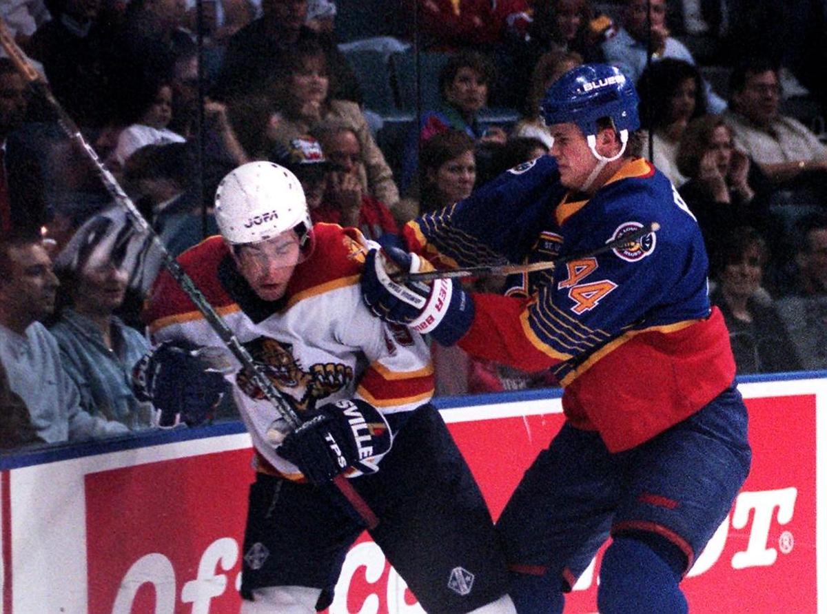 St. Louis defenseman Chris Pronger checks Florida forward Radek Dvorak at Miami Arena in 1997.