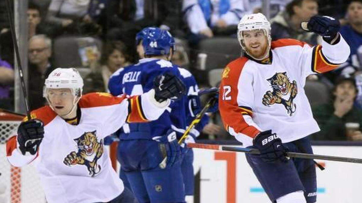 
Florida Panthers' Jimmy Hayes (12) and Jussi Jokinen (36) celebrate their team's goal as Toronto Maple Leafs' Morgan Rielly (44) looks on during the second period of an NHL hockey game in Toronto, Tuesday, Feb. 17, 2015. 
