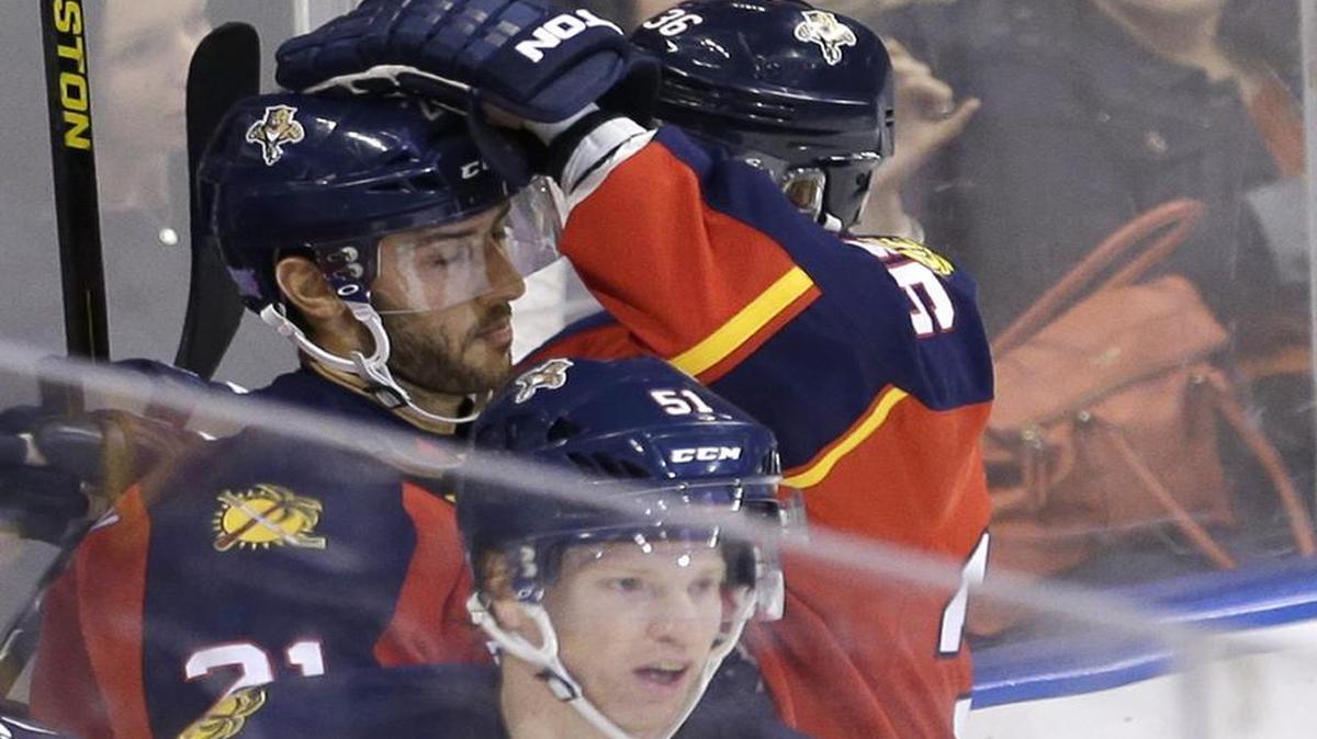 Florida Panthers center Vincent Trocheck (21) is congratulated by teammate Jussi Jokinen (36) after Trocheck scored against the Colorado Avalanche in the first period of an NHL hockey game, Tuesday, Oct. 27, 2015, in Sunrise, Fla.