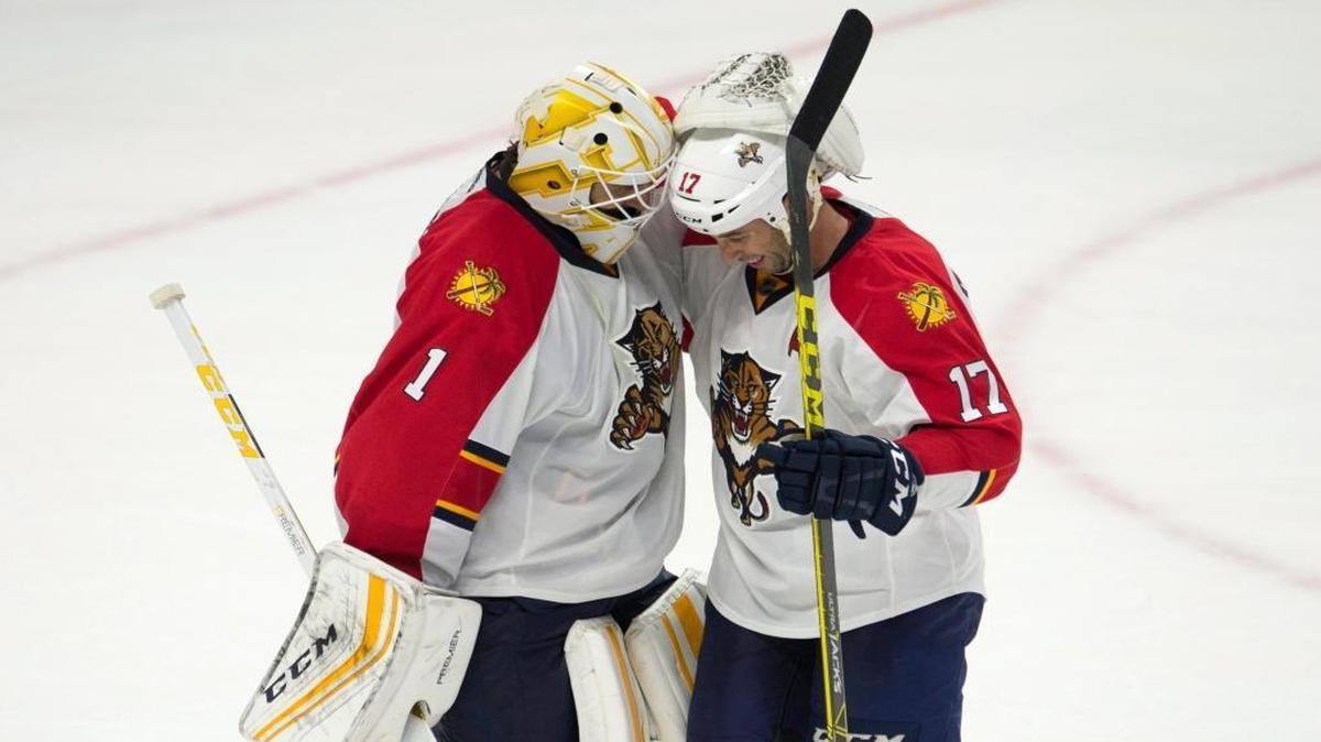 Panthers goalie Roberto Luongo, left, celebrates with center Derek MacKenzie after beating the Senators. Luongo made 31 saves for the Panthers’ 11th win in a row.