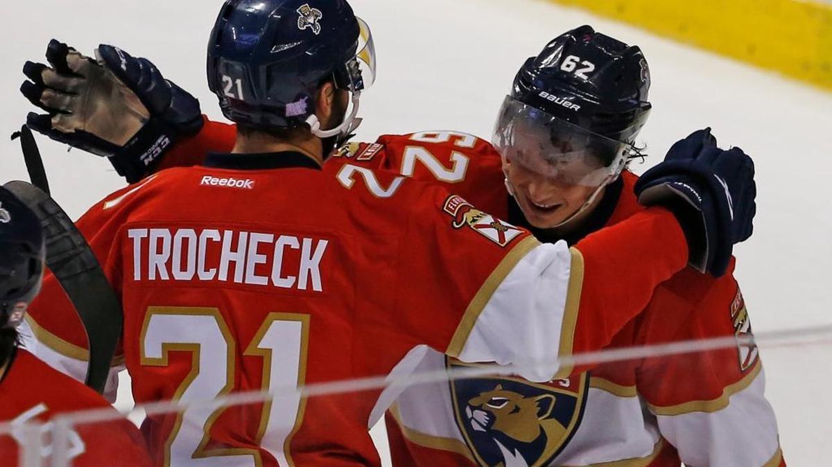 Florida Panthers center Vincent Trocheck (21) celebrates with teammate Denis Malgin (62) who scored the winning goal in overtime to defeat the New York Islanders in an NHL hockey game, Saturday, Nov. 12, 2016, in Sunrise, Fla.