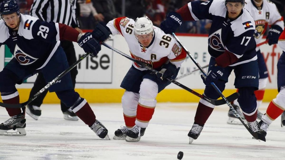 Florida’s Jussi Jokinen battles Colorado’s Nathan MacKinnon and Rene Bourque on Dec. 16.