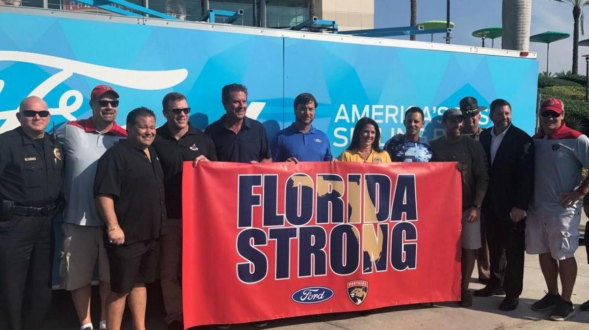 Dan Marino, center, joins members of the Florida Panthers, South Florida Ford and state Senator Anitere Flores outside BB&T Center in Sunrise on Tuesday morning.