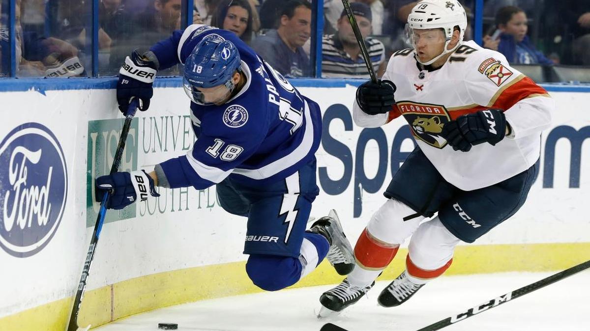 Tampa Bay Lightning left wing Ondrej Palat (18), of the Czech Republic, gets tripped up by Florida Panthers defenseman Mike Matheson (19) during the second period of an NHL hockey game Friday, Oct. 6, 2017, in Tampa, Fla.