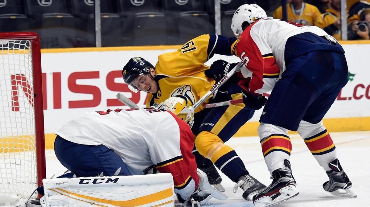 Florida Panthers goalie Roberto Luongo (1) covers up the puck after a shot by Nashville Predators center Calle Jarnkrok (19), of Sweden, as Panthers defenseman Aaron Ekblad (5) defends in second period of an NHL hockey game Thursday, Dec. 3, 2015, in Nashville, Tenn.