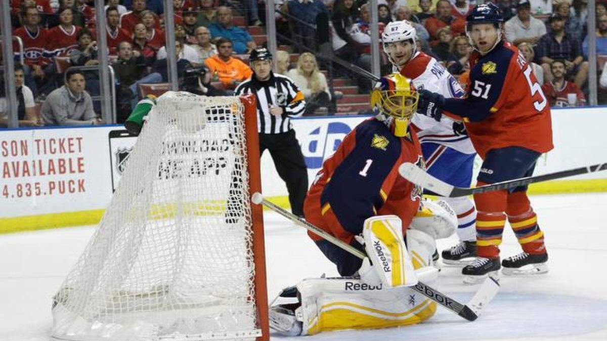
Close call: Panthers goalie Roberto Luongo watches the puck slide wide of the net in the first period on Tuesday night against the Canadiens. 
