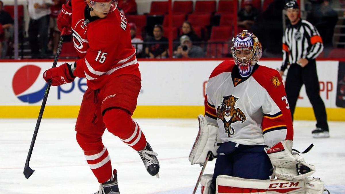 
Carolina Hurricanes’ Andrej Nestrasil (15) eyes the puck as it is gloved by Florida Panthers goalie Al Montoya (35) during the second period Tuesday, Oct. 13, 2015, in Raleigh, N.C. 
