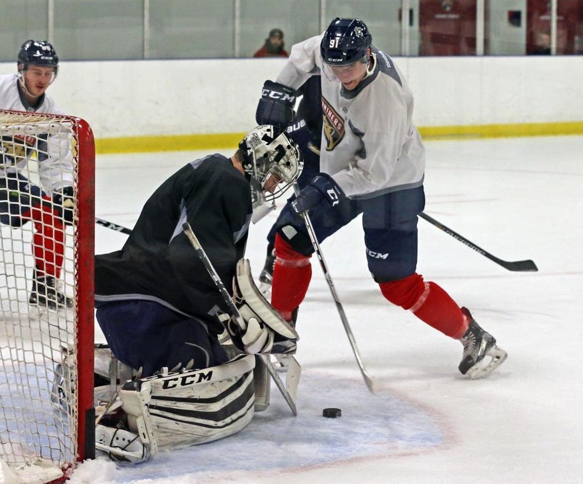 Juho Lammikko hits the puck at goalie Samuel Montembeault at the Florida Panthers rookie camp in Coral Springs on September 16, 2016.