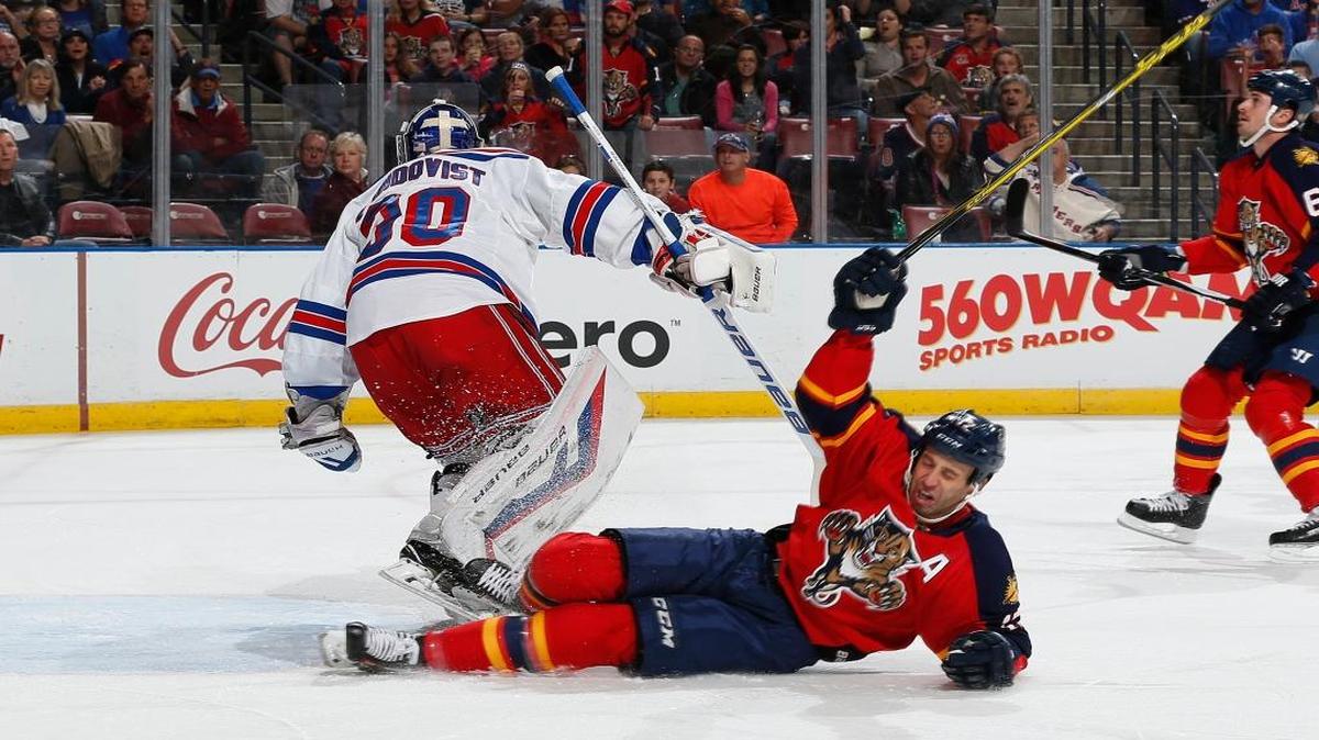 New York Rangers goaltender Henrik Lundqvist (30) defends the net as Florida Panthers forward Derek MacKenzie (17) is taken to the ice during the first period of an NHL hockey game, Saturday, Nov. 21, 2015, in Sunrise, Fla.