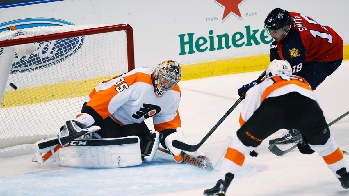 
Florida Panthers right wing Reilly Smith (18) scores a goal against Philadelphia Flyers goalie Steve Mason (35) and defenseman Michael Del Zotto (15) during the first period of an NHL hockey game, Saturday, Oct. 10, 2015, in Sunrise, Fla. 
