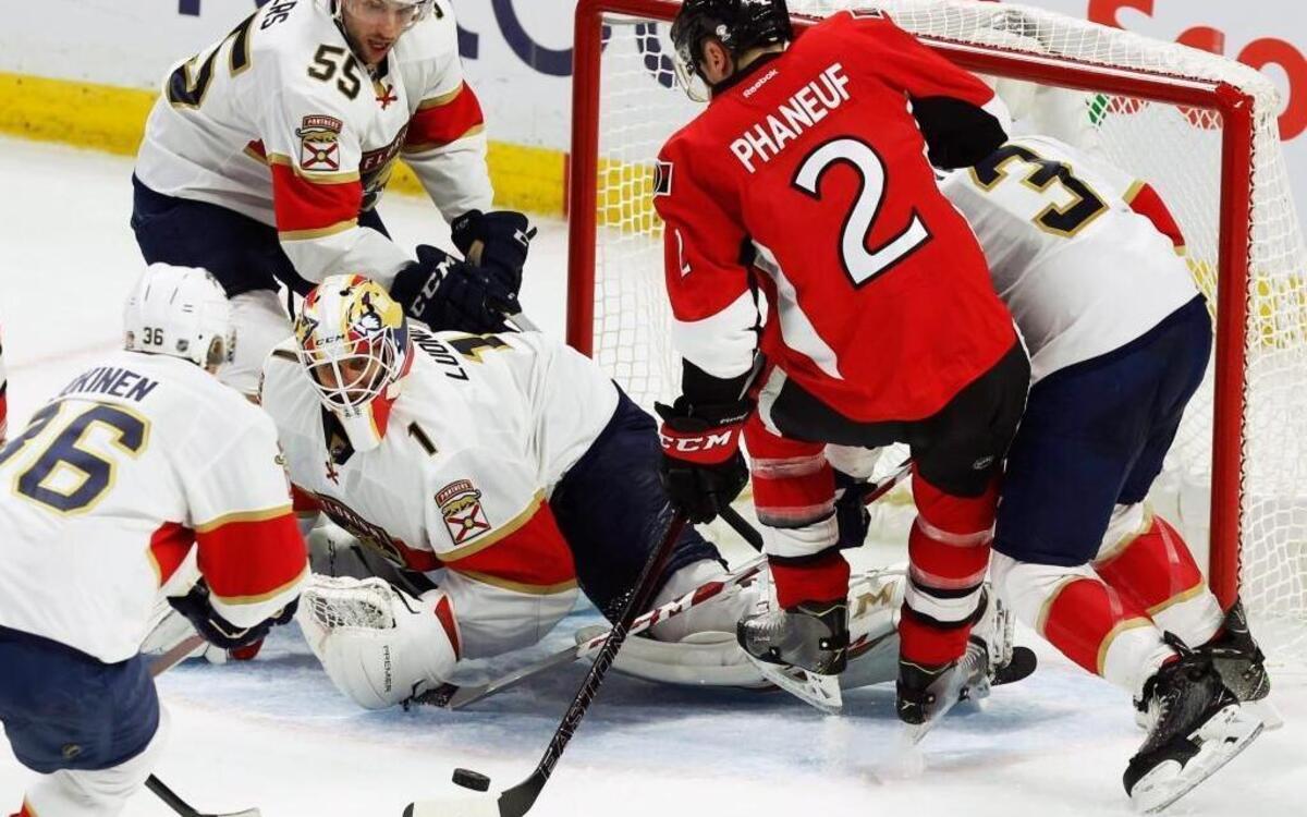 Florida Panthers goaltender Roberto Luongo (1) keeps his eyes on the puck as the Ottawa Senators’ Dion Phanuef (2) attempts to shoot. Luongo made several spectacular saves among his many, including a couple of flurries in the third period when the Senators were pressing to get back into the game.