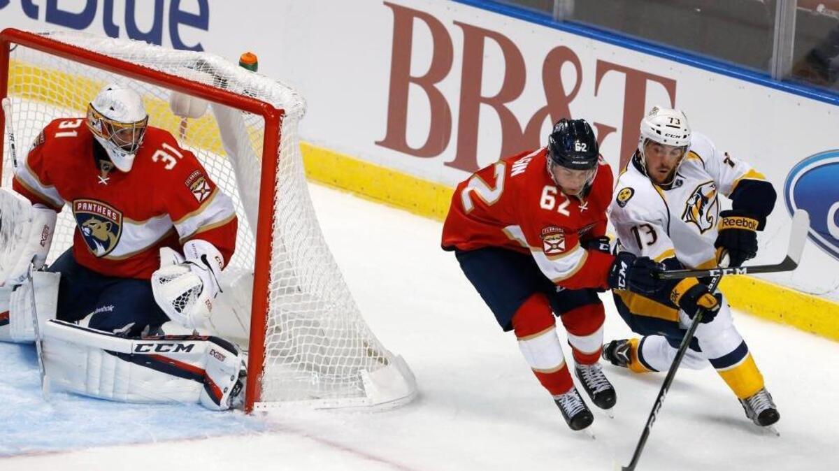 Florida forward Denis Malgin battles Nashville’s Felix Girard for the puck in the Panthers 4-1 preseason opening win Tuesday at BB&T Center.