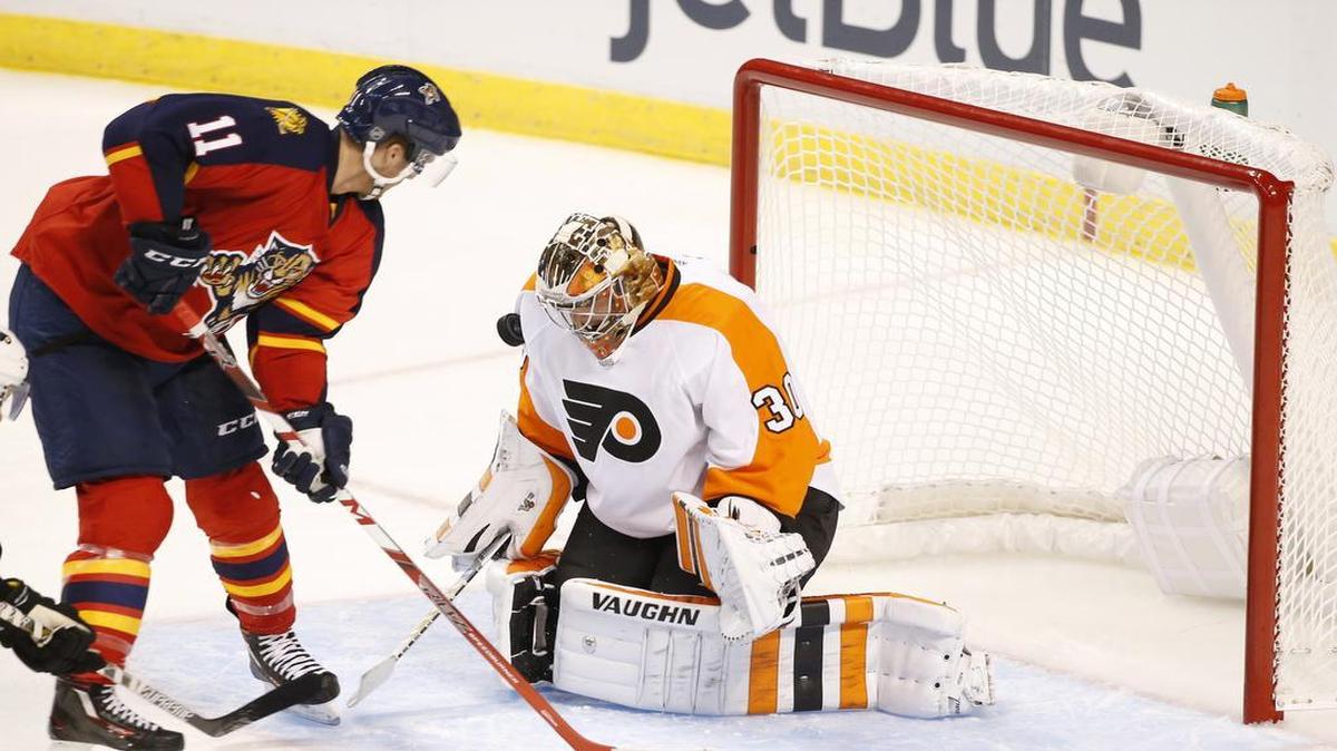 
Florida Panthers center Jonathan Huberdeau (11) attempts a shot at Philadelphia Flyers goalie Michal Neuvirth (30) during the second period of an NHL hockey game, Saturday, Oct. 10, 2015 in Sunrise, Fla. 
