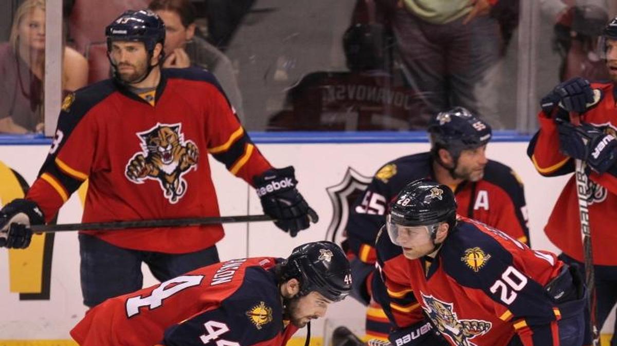 The Florida Panthers watch as the New Jersey Devils celebrate their double-overtime win in Game 7 of their first-round Stanley Cup Playoffs series at the BankAtlantic Center in Sunrise on April 26, 2012.