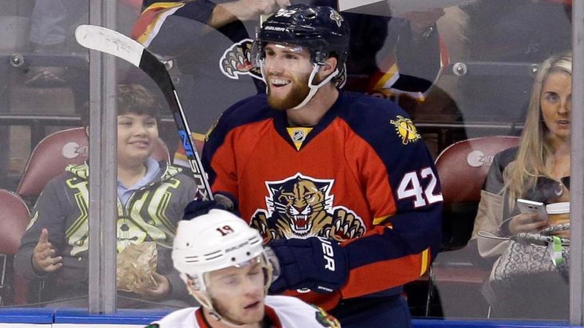 Florida Panthers center Quinton Howden (42) smiles after scoring a goal as Chicago Blackhawks center Jonathan Toews (19) skates by during the first period Friday, Jan. 22, 2016, in Sunrise, Fla.