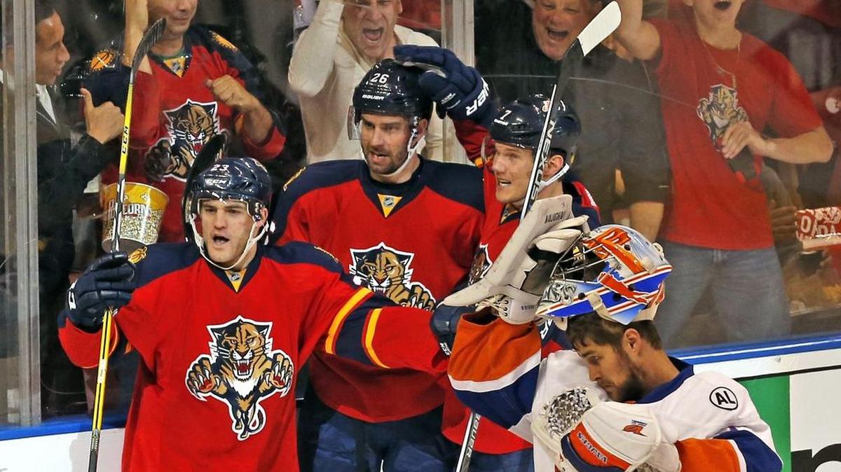 The Panthers’ Rocco Grimaldi, left, recently called up from the minors, celebrates after a goal by Teddy Purcell, center, during the first period of Thursday night’s playoff game.
