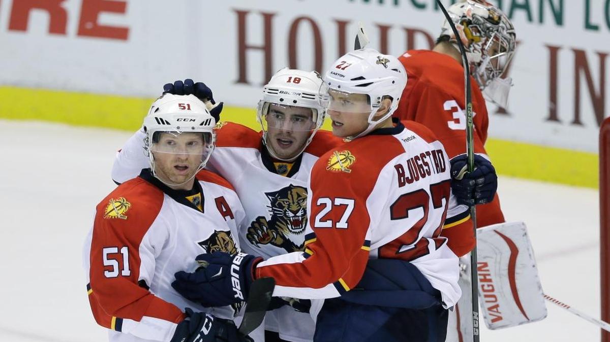 Florida Panthers right wing Reilly Smith (18), celebrates his goal with defenseman Brian Campbell (51) and center Nick Bjugstad (27) in front of Detroit Red Wings goalie Petr Mrazek (34) during the third period Sunday, Nov. 29, 2015, in Detroit.