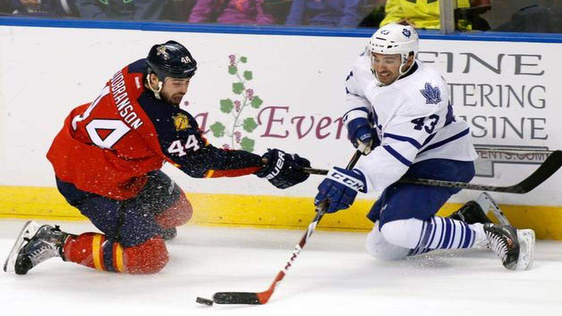 
Florida Panthers defenseman Erik Gudbranson (44) and Toronto Maple Leafs center Nazem Kadri (43) fight for the puck during the second period of an NHL hockey game Sunday, Dec. 28, 2014, in Sunrise, Fla.
