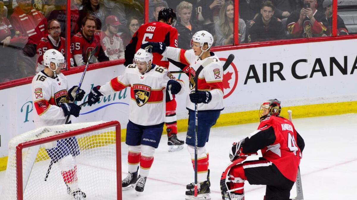 The Panthers’ Sasha Barkov (16) and Nick Bjugstad, right, celebrate after Evgenii Dadonov, center, scored one of Florida’s four goals in the second period against Senators goaltender Craig Anderson on Tuesday night in Ottawa.
