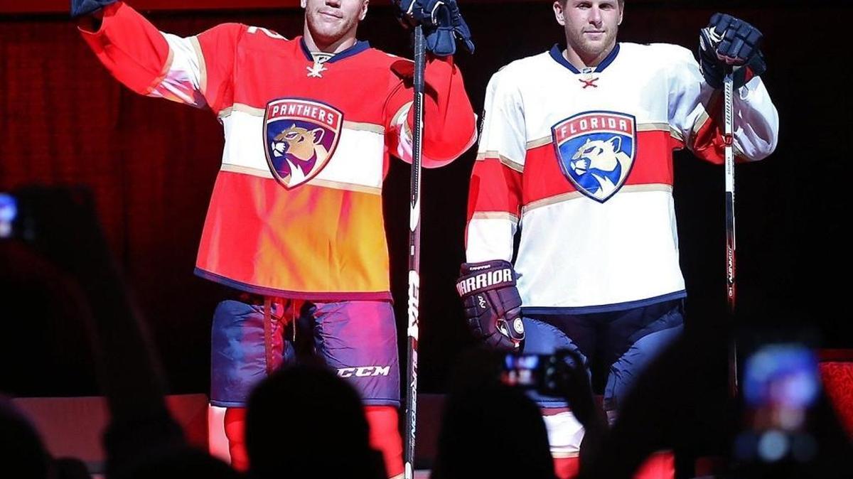 Shawn Thornton, left, and teammate Steven Kampfer show off the Florida Panthers new uniforms at the unveiling event at BB&T Center in June.