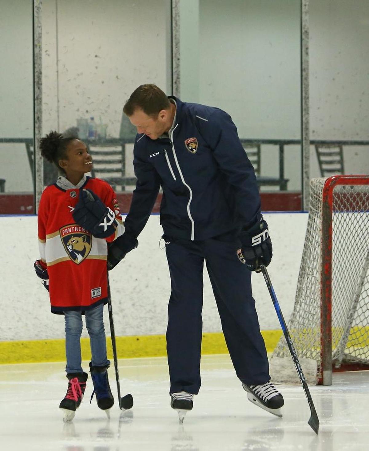 Former Florida Panthers player and now vice president of business operations Shawn Thornton gives a private hockey clinic to eleven-year-old Jessica King of Barbados at the Florida Panthers IceDen in Coral Springs on Wednesday, December 6, 2017. Thornton met Jessica in August when they hosted the first ice hockey clinic in the Caribbean on a synthetic ice rink in Barbados.