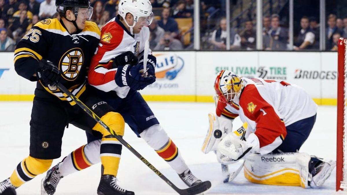 Florida Panthers' Roberto Luongo (1) blocks a shot as Aaron Ekblad (5) keeps Boston Bruins' Matt Fraser (25) from the rebound in the second period of an NHL hockey game in Boston, Tuesday, Nov. 4, 2014.