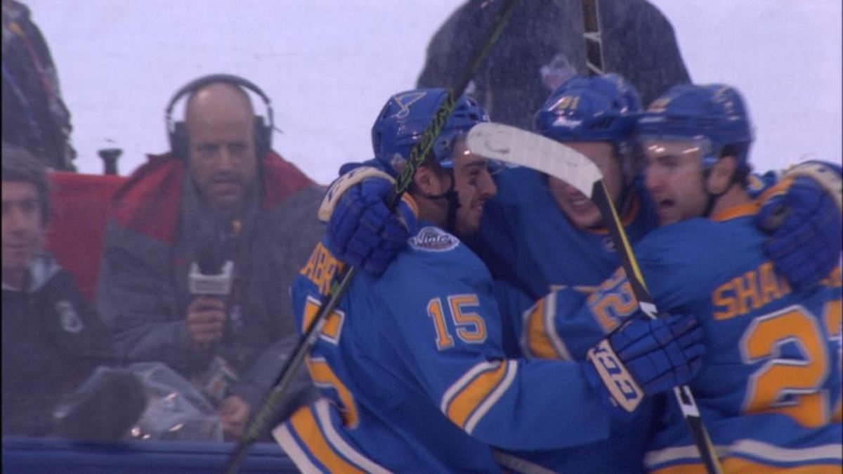 Players from the St. Louis Blues celebrate the game-winning goal in the 2017 NHL Winter Classic in front of Florida Panthers broadcaster Steve Goldstein.