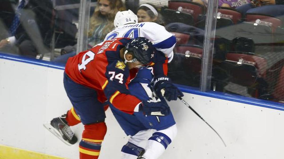 
Florida Panthers' Shane O'Brien (74) and Tampa Bay Lightning Ryan Callahan (24) fight for the puck during the first period of a NHL hockey game in Sunrise, Fla., Thursday, Oct. 2, 2014.

