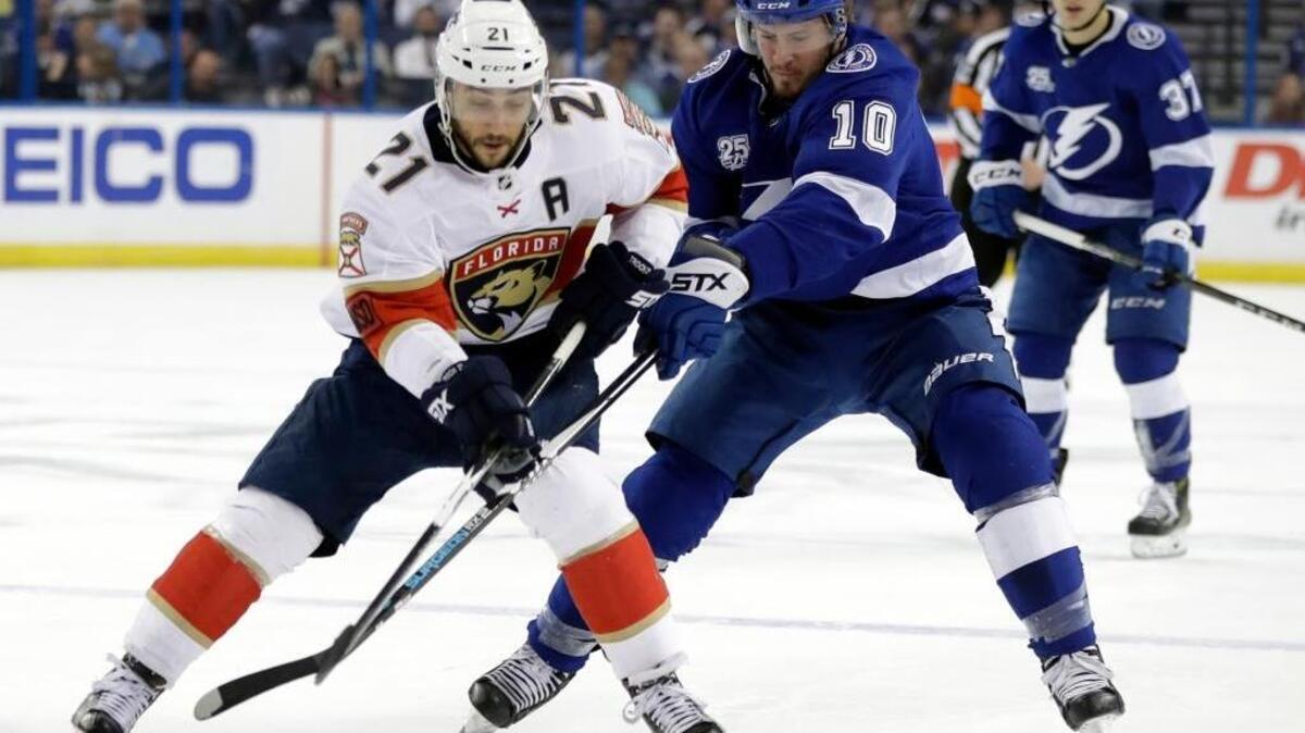 Florida Panthers center Vincent Trocheck (21) beats Tampa Bay Lightning center J.T. Miller (10) to a loose puck during the first period of an NHL hockey game Tuesday, March 6, 2018, in Tampa, Fla.