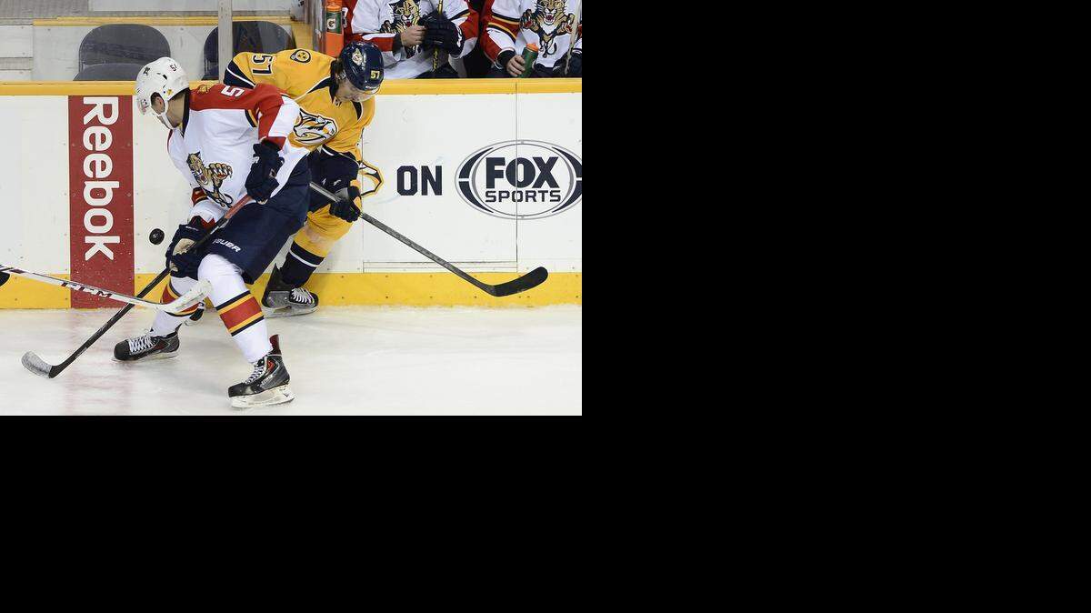 
Florida Panthers defenseman Aaron Ekblad steals the puck from Nashville Predators left wing Gabriel Bourque in the first period of a preseason game Saturday, Sept. 27, 2014, in Nashville, Tenn. 
