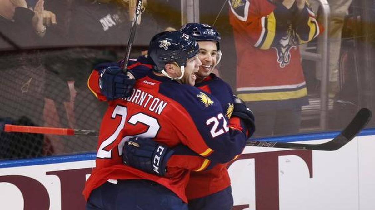 
Florida Panthers' Shawn Thornton (22) celebrates with Derek Mackenzie (17) after he scored the first goal of the game against the Winnipeg Jets during the first period of an NHL hockey game in Sunrise, Fla., Thursday, March 12, 2015. 
