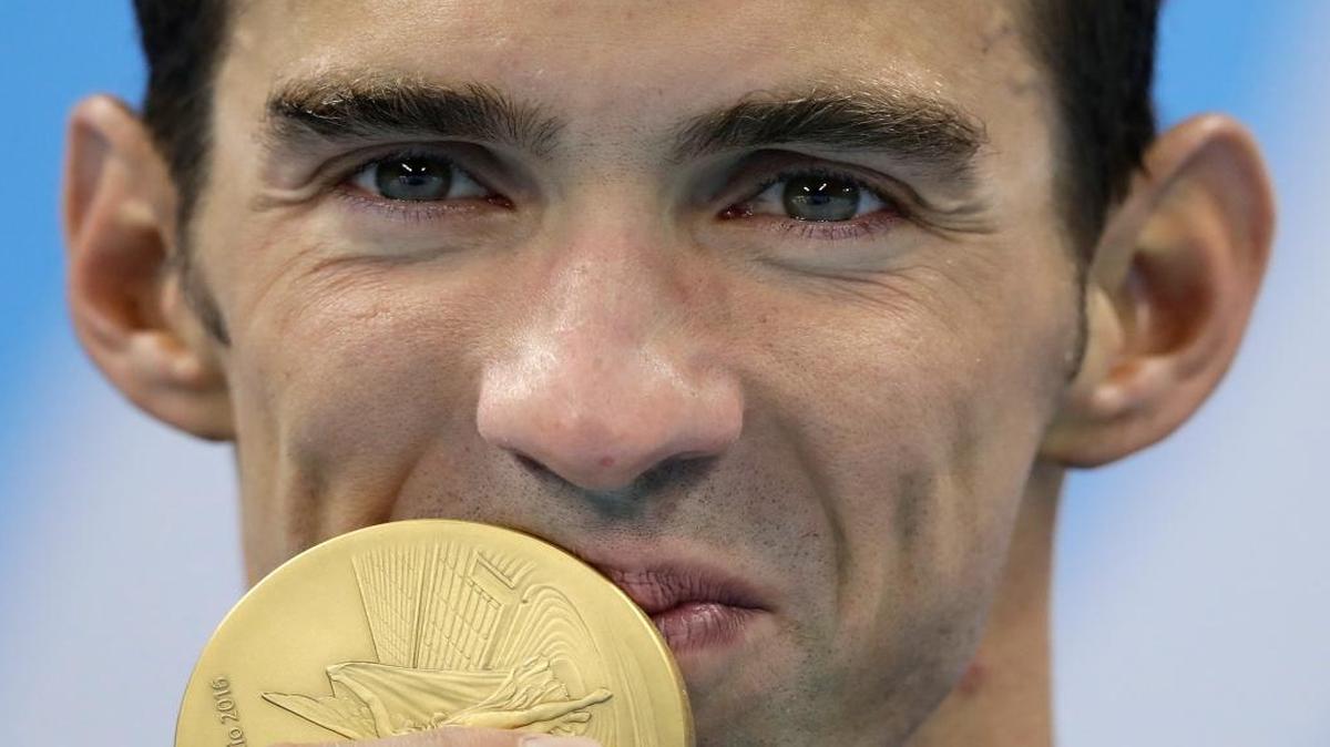 United States' Michael Phelps kisses the gold medal during the medal ceremony for the men's 200-meter individual medley final during the swimming competitions at the 2016 Summer Olympics, Thurs., Aug. 11, 2016, in Rio de Janeiro, Brazil.
