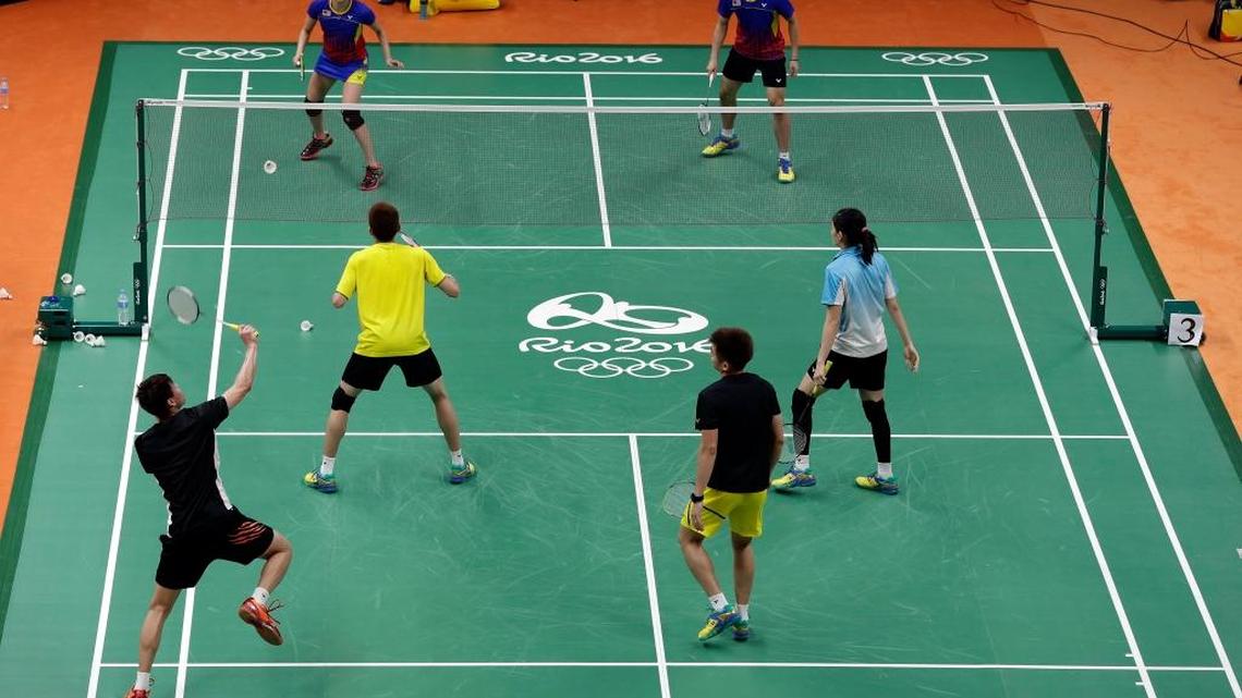 Badminton players take part in a training session at Riocentro before their next match.