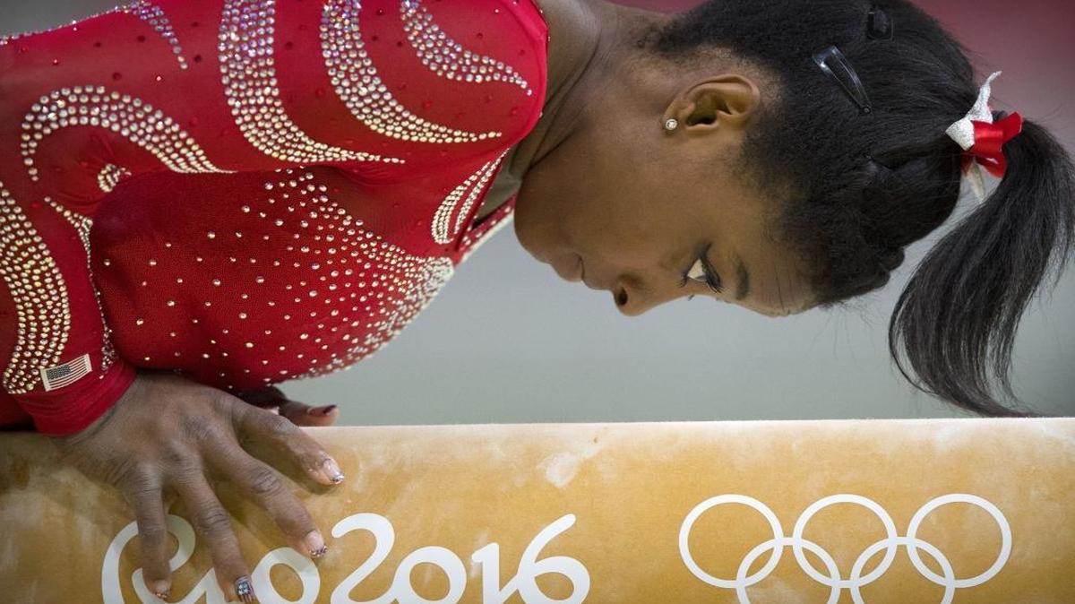 U.S. gymnast Simone Biles practices her balance beam routine on Thurs., Aug. 4, 2016, during a training session at the Rio Olympic Arena in Rio de Janeiro, Brazil. Biles, is a three-time world all-around champion, but is competing in her first Olympic Games.