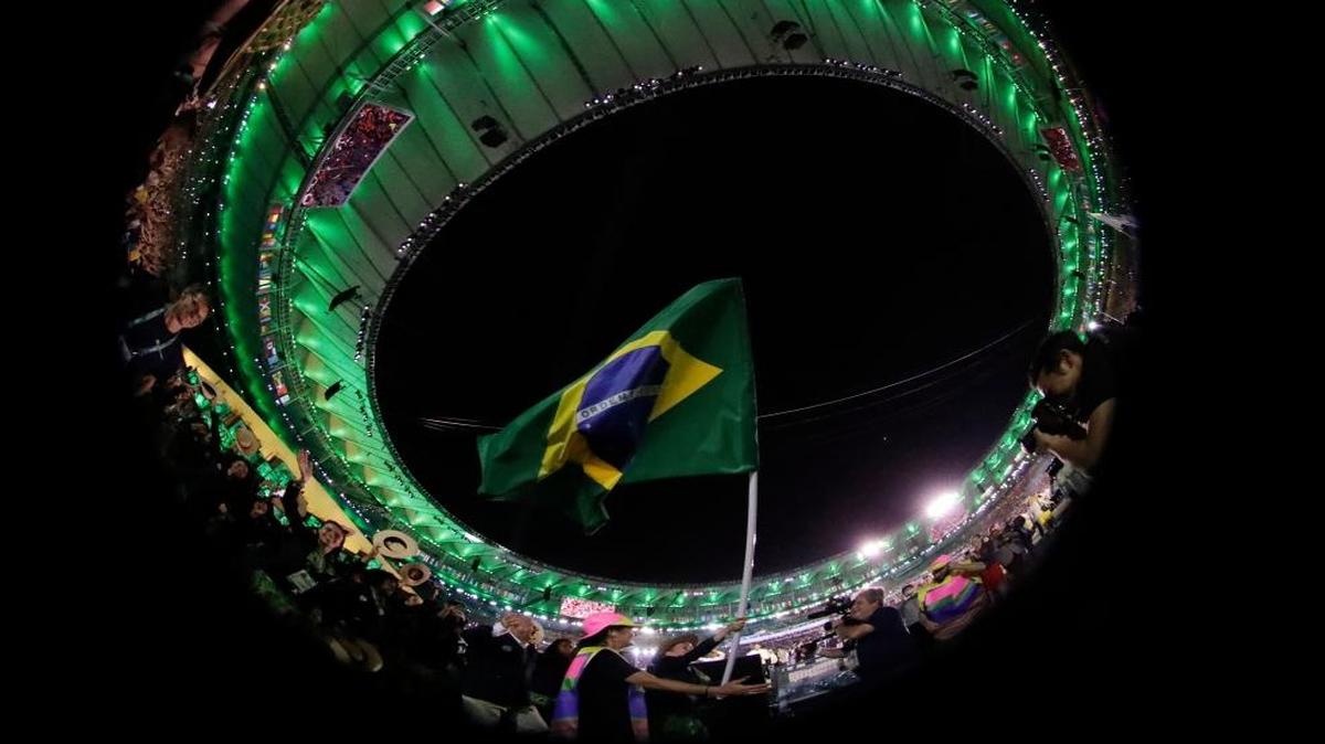 In this photo taken with a fish-eye lens, the Brazilian flag is raised during the opening ceremony for the 2016 Summer Olympics in Rio de Janeiro, Brazil, Fri., Aug. 5, 2016.