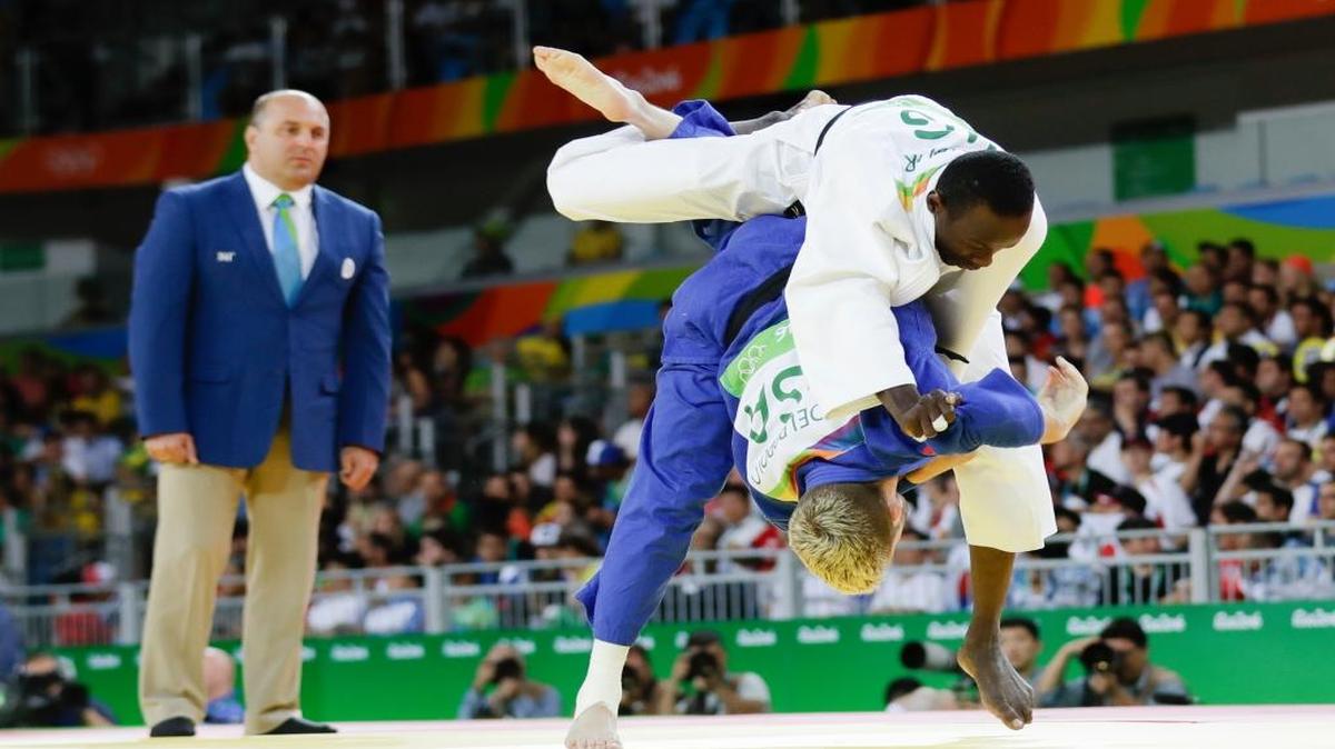 American Nicholas Delpopolo, takes down Niger's Ahmed Goumar. Delpopolo, who was sent home from the 2012 Olympics for a positive drug test, finished seventh in Rio.