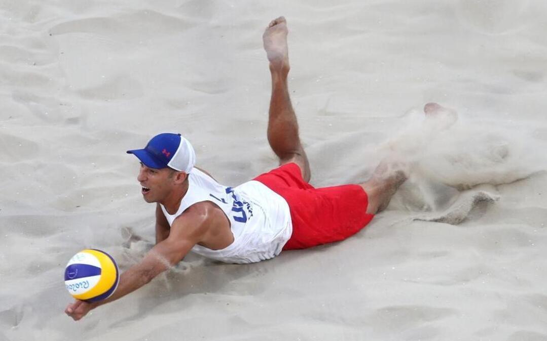 Nick Lucena of Cooper City dives for a ball during his opening victory with partner Phil Dalhausser on Sunday.
