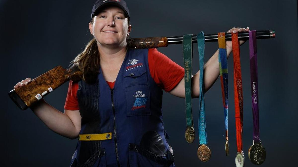 Double trap and skeet shooter Kim Rhode poses for photos with her five Olympic medals. She will be going for an unprecedented sixth in a row for an American athlete in an individual sport at the Rio Olympics on Friday.