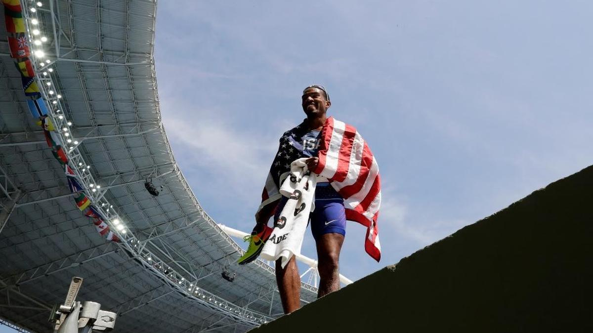 United States' Christian Taylor celebrates with the U.S. flag after winning the gold medal in the men's triple jump final during the athletics competitions of the 2016 Summer Olympics at the Olympic stadium in Rio de Janeiro, Brazil, Tues., Aug. 16, 2016.