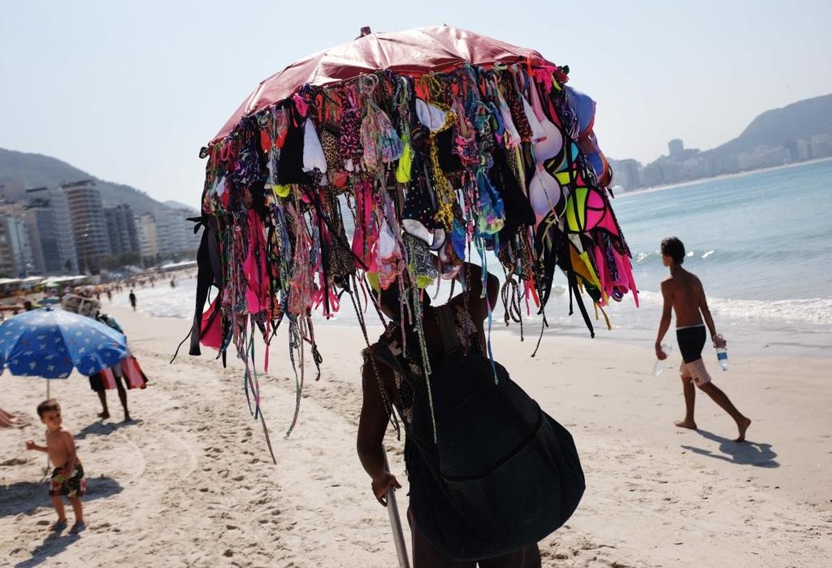 A vendor sells bikinis along Copacabana Beach ahead of the upcoming Summer Olympics in Rio de Janeiro, Brazil, on Tuesday, Aug. 2, 2016. One will cost you $10.