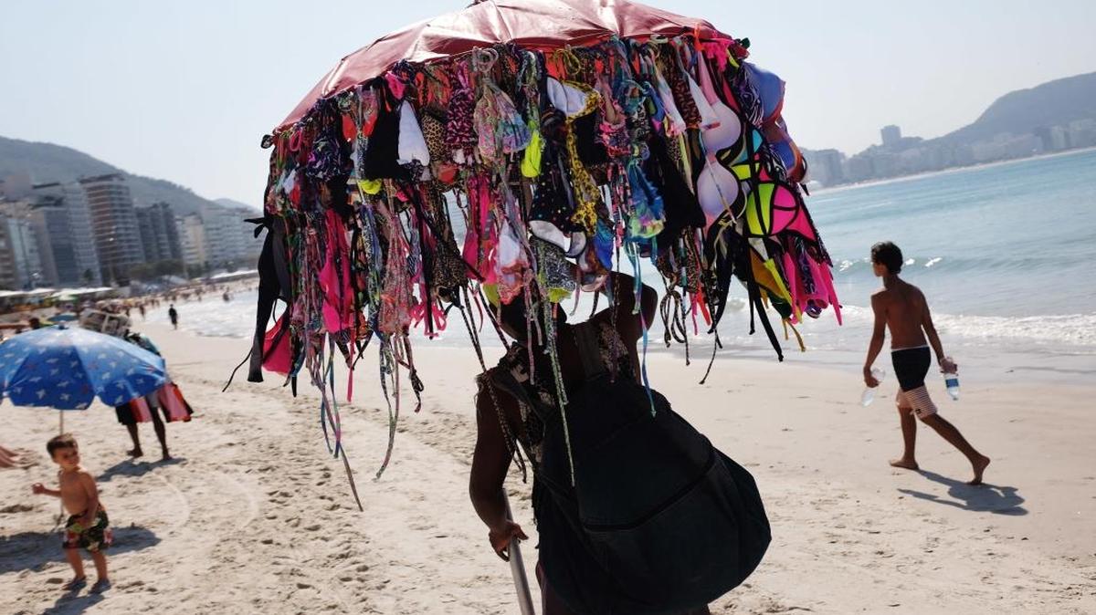 A vendor sells bikinis along Copacabana Beach ahead of the upcoming Summer Olympics in Rio de Janeiro, Brazil, on Tuesday, Aug. 2, 2016. One will cost you $10.