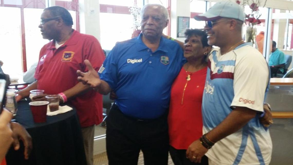 West Indies cricket legend Lance Gibbs, center, poses for a photo with fans during the second annual Cricket Legends Weekend at Central Broward Regional Park in Lauderhill, Florida, on Sunday, March 6, 2016.