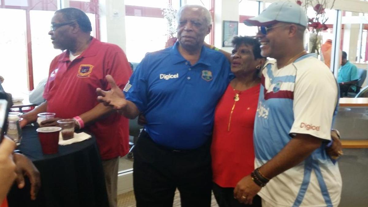 West Indies cricket legend Lance Gibbs, center, poses for a photo with fans during the second annual Cricket Legends Weekend at Central Broward Regional Park in Lauderhill, Florida, on Sunday, March 6, 2016.